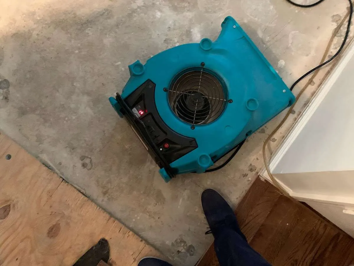 Air mover drying subfloor during Commercial Water Damage Restoration in Murrysville